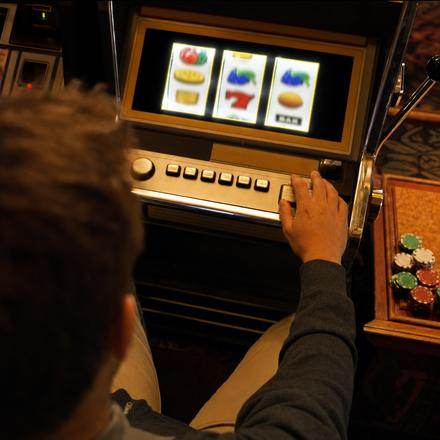 Overhead photo of a player at a slot machine